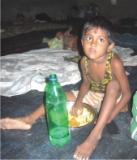 A little girl eating in a relief camp