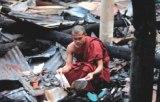 A Buddhist monk salvaging singed documents