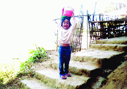 Young girl carrying water