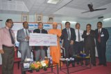 SBI Managing Director A. Krishna Kumar handing over a cheque of 20 lacs to Swami Vishweshananda. SBI Managing Director A. Krishna Kumar handing over a cheque of 20 lacs to Swami Vishweshananda.