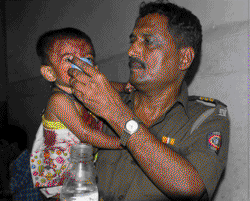 A police officer nursing an orphaned child